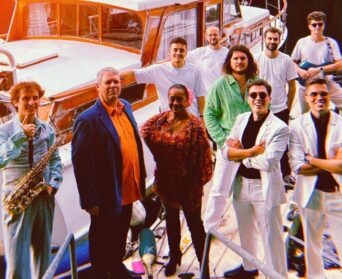 The Yacht Brothers band posing on a yacht